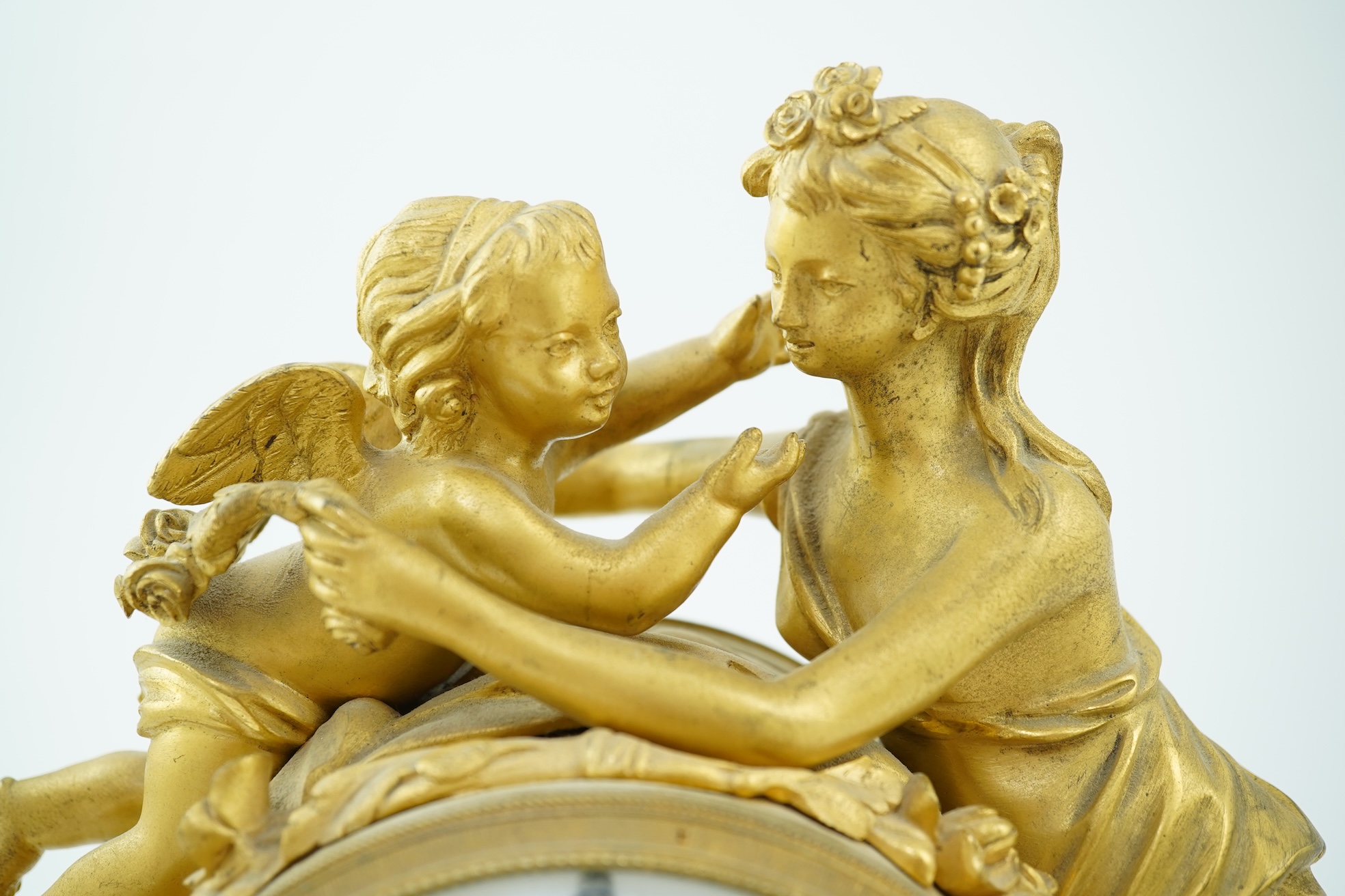 An early 19th century French figural ormolu and white marble mantel clock